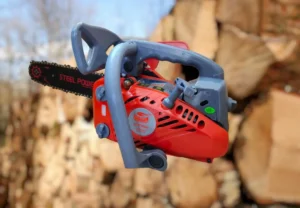 Steel Power STP3000 12-inch chainsaw with red body and gray handles available from Joo Huat Chai Kee Malaysia