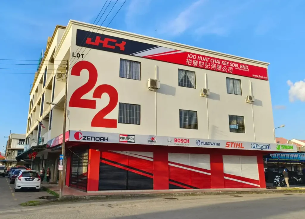 Multi-story commercial building housing Joo Huat Chai Kee automotive parts and machinery distributor with brand displays